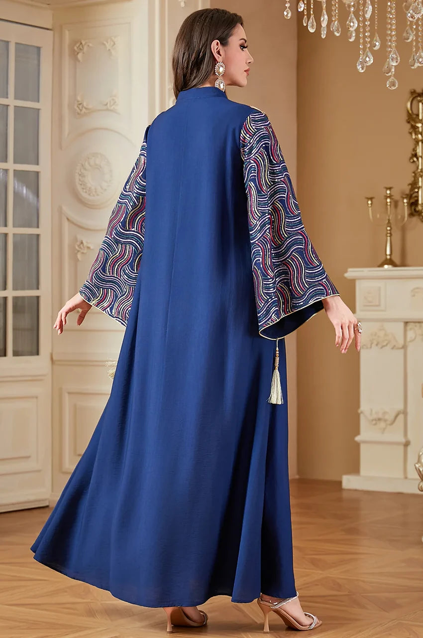 Model displaying the wide sleeves of the navy sequin kaftan.