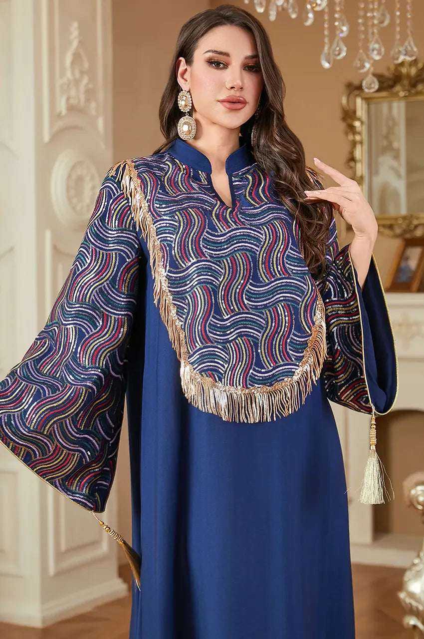 Close up of multicolored sequin details on navy blue fabric.