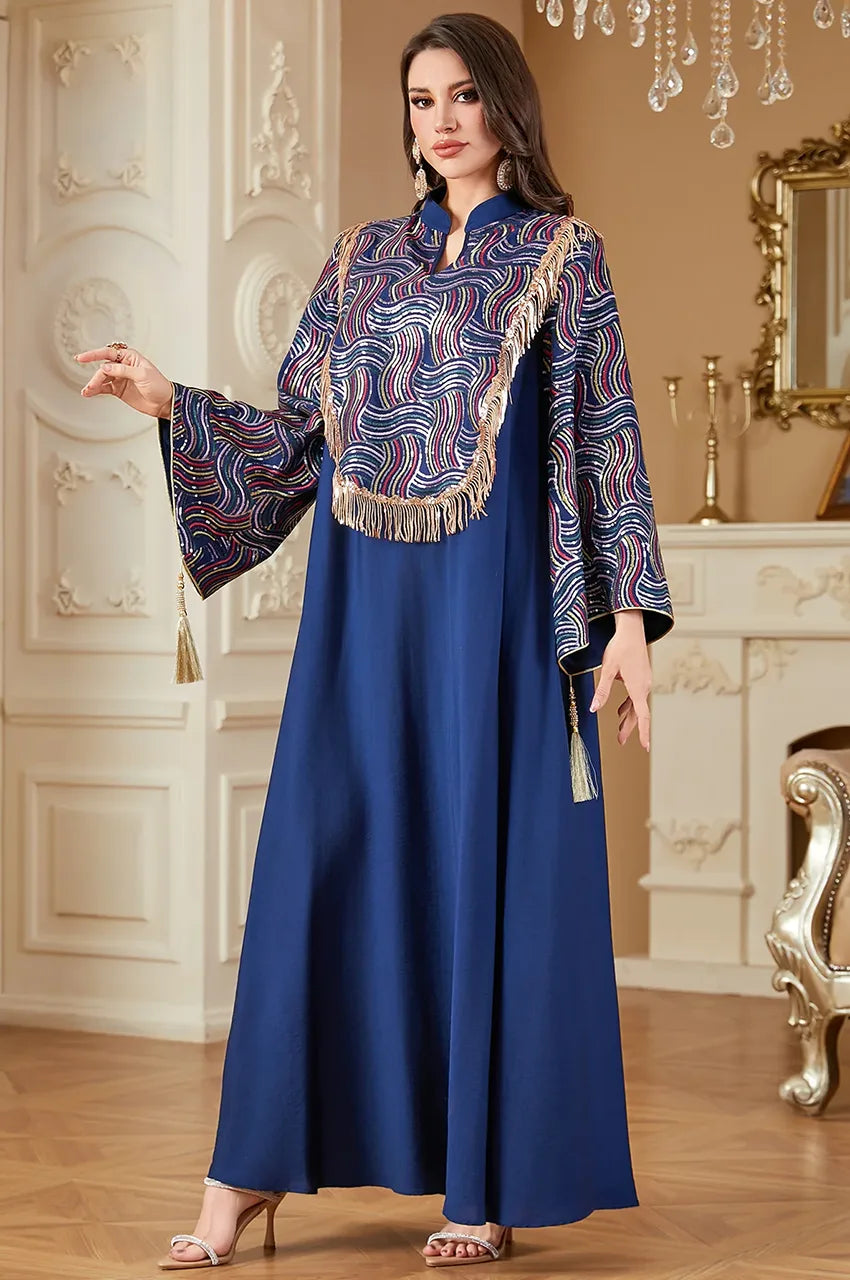 Aziah blue kaftan dress in motion showing sleeve tassels.