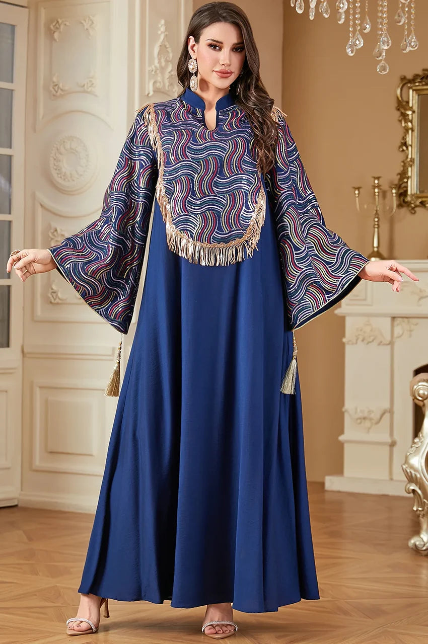 Model displaying the wide sleeves of the navy sequin kaftan.