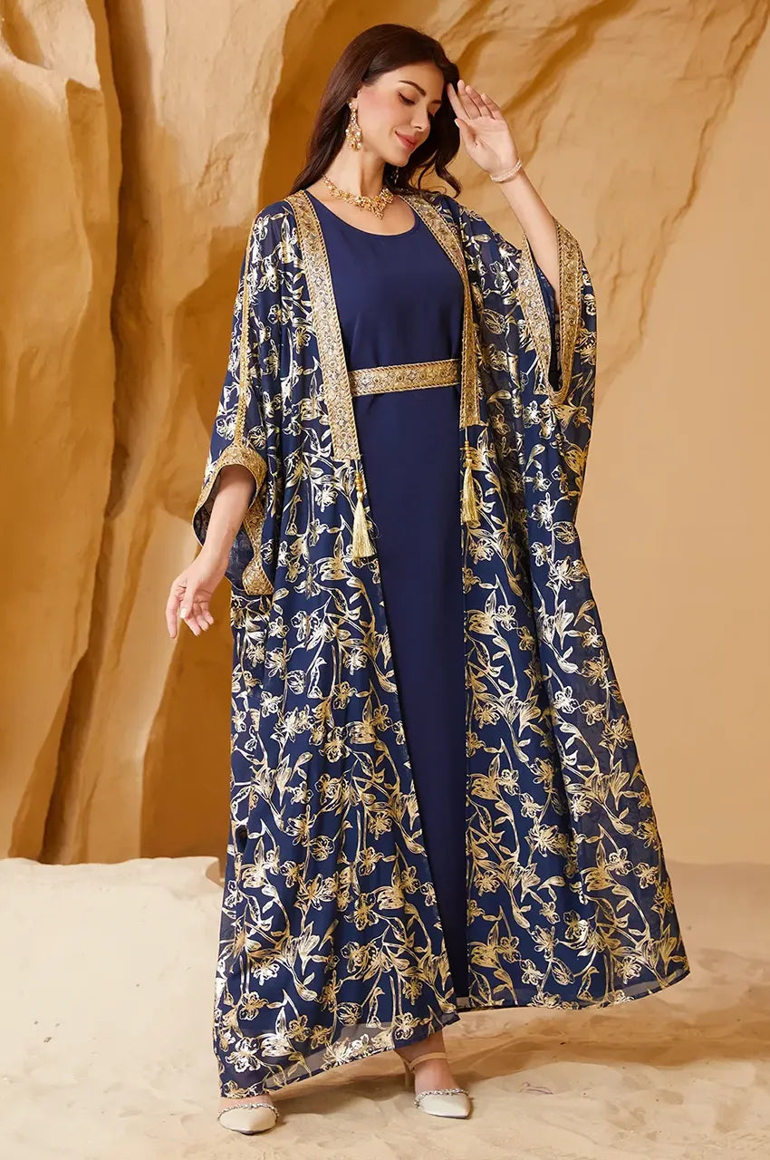 Detail view of the shimmering gold foil botanical print on the navy long open kaftan canvas.