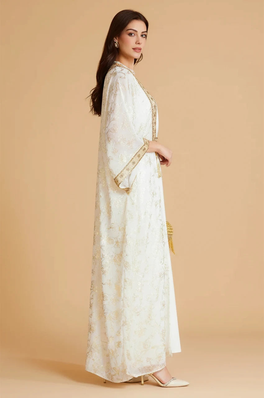 Side profile of the Aziri white kaftan highlighting the sheer overlay and wide butterfly sleeves.