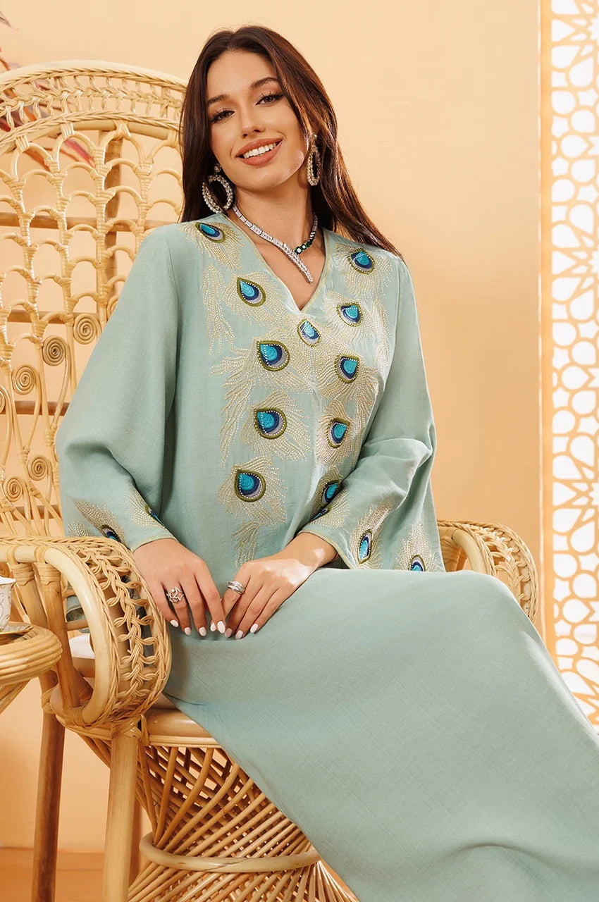 Close-up of peacock embroidery on green Azura kaftan