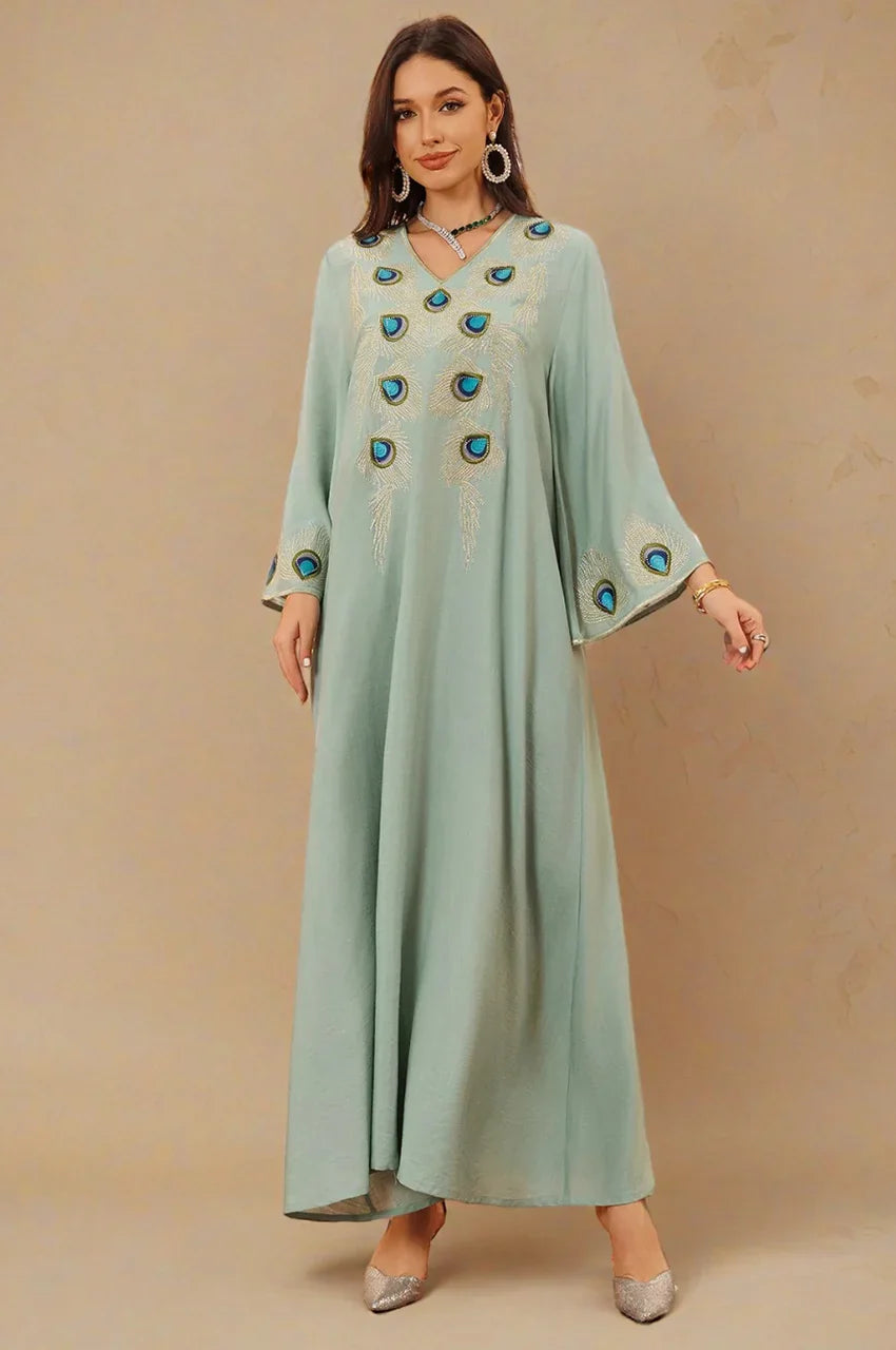 Angled front view of Azura Green Peacock Kaftan showing peacock feather embroidery