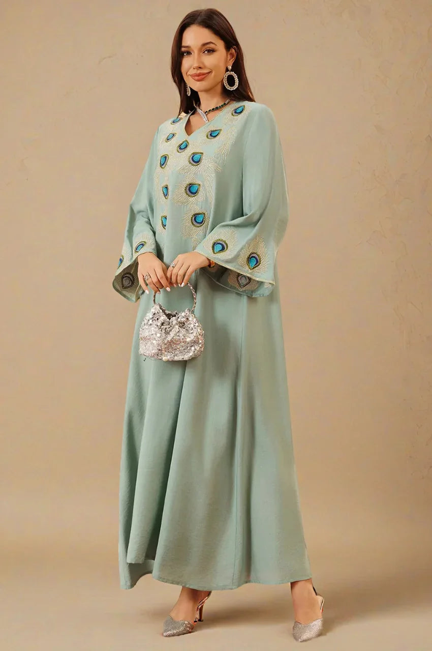 Lifestyle photo of Azura Green Peacock Kaftan with blue and gold feather embroidery