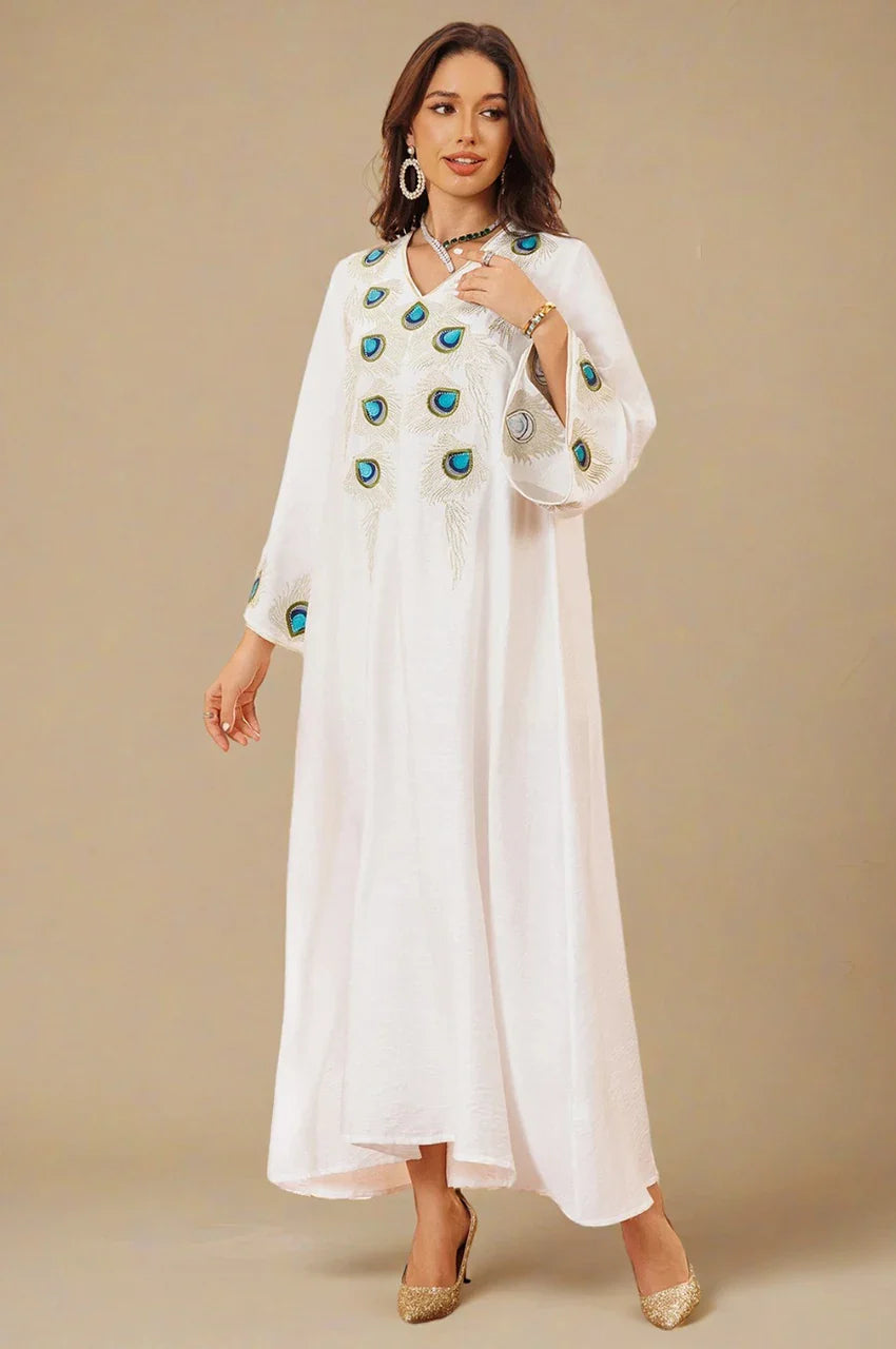 Angled front view of Azura White Peacock Kaftan with detailed peacock feather motifs