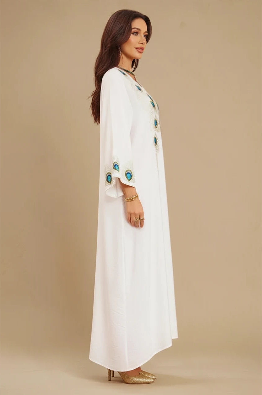 Side profile of Azura White Peacock Kaftan showing peacock embroidery on sleeves