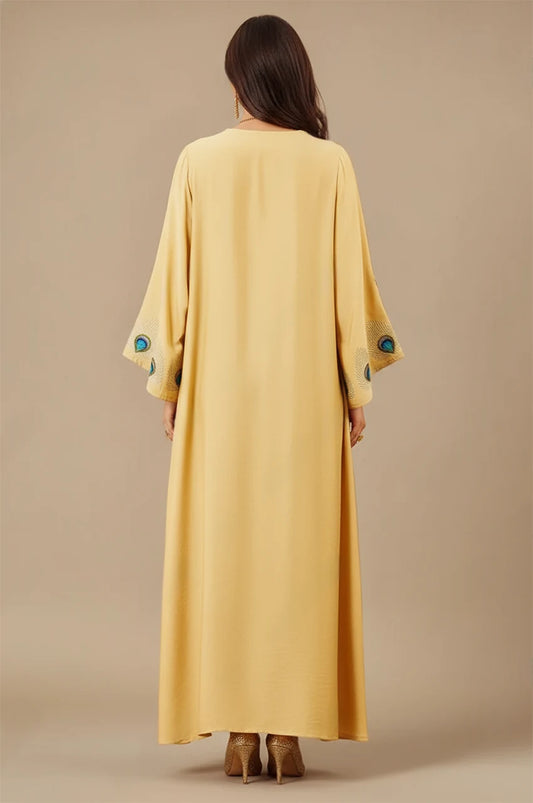Back view of Azura Yellow Peacock Kaftan with flowing golden fabric