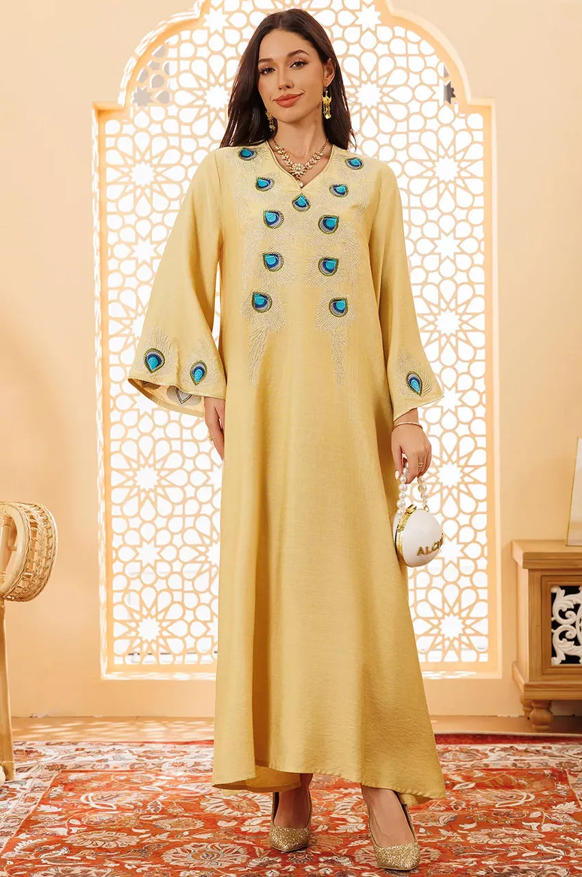 Front view of Azura yellow peacock embroidered kaftan in luxury setting