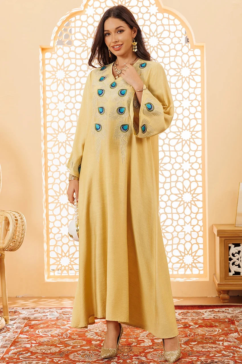 Full body shot of Azura yellow peacock kaftan