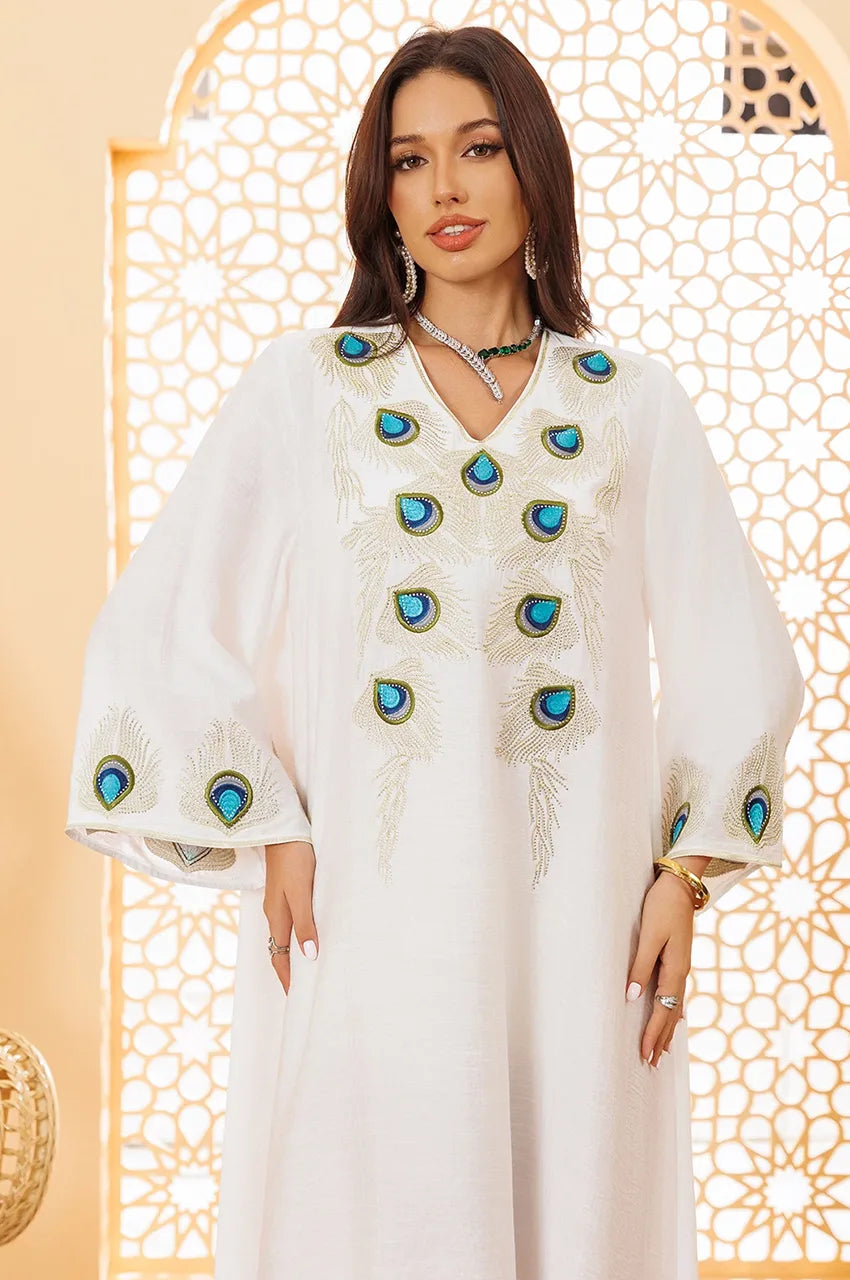 Close-up peacock embroidery on white Azura kaftan