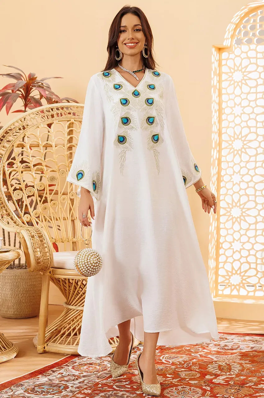 Lifestyle shot of Azura white peacock kaftan in decor setting