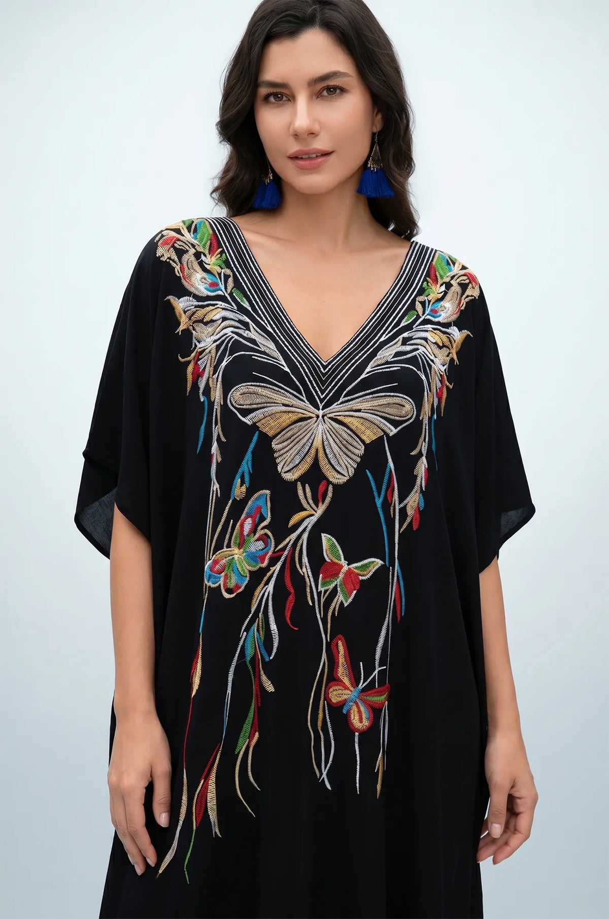 Front detail of black kaftan with gold butterfly embroidery and V-neckline