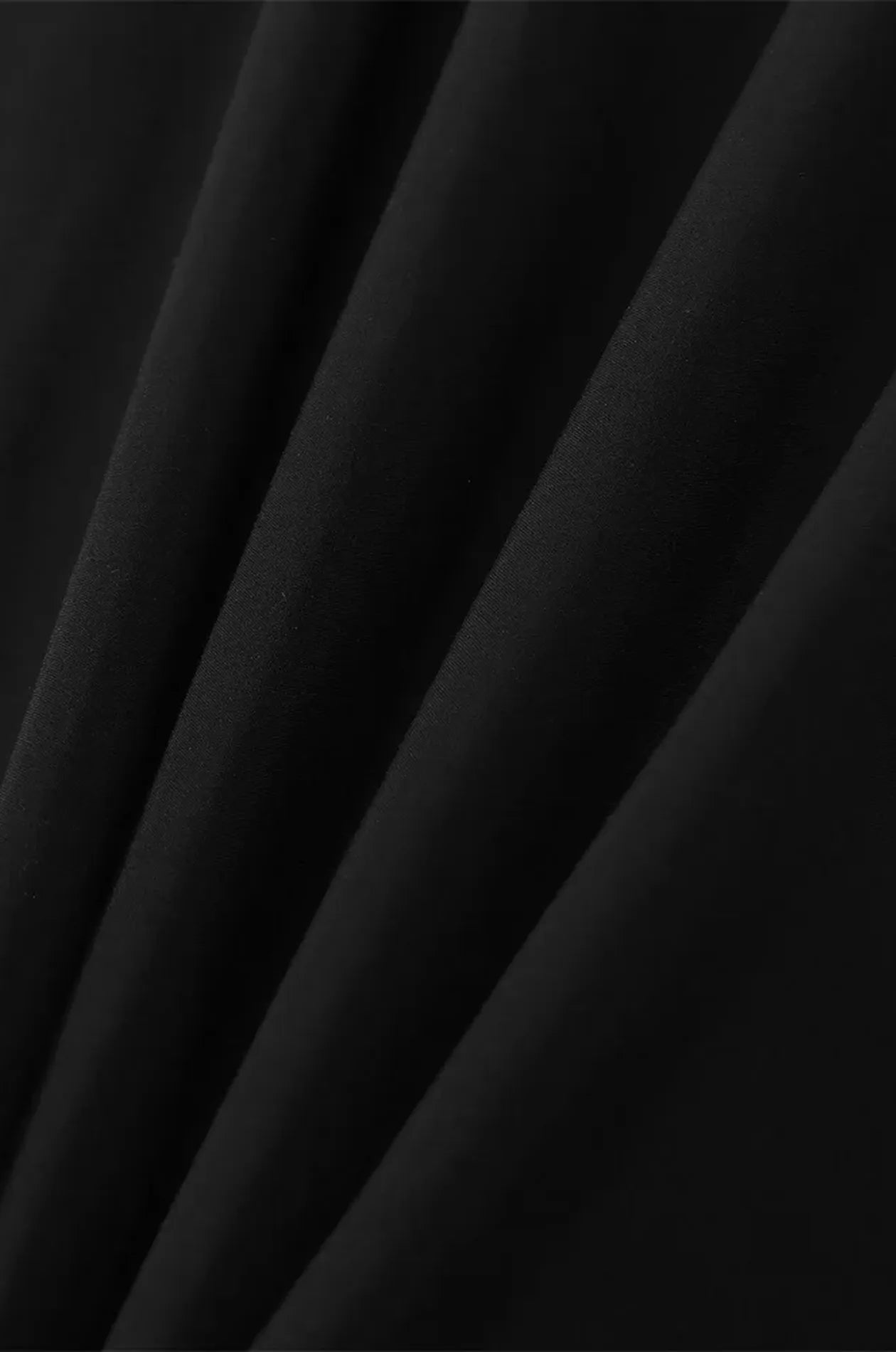 Close-up of lightweight black kaftan fabric drape and texture