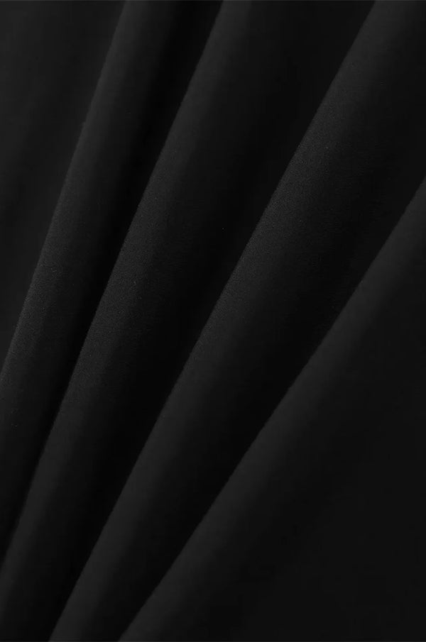 Close-up of lightweight black kaftan fabric drape and texture