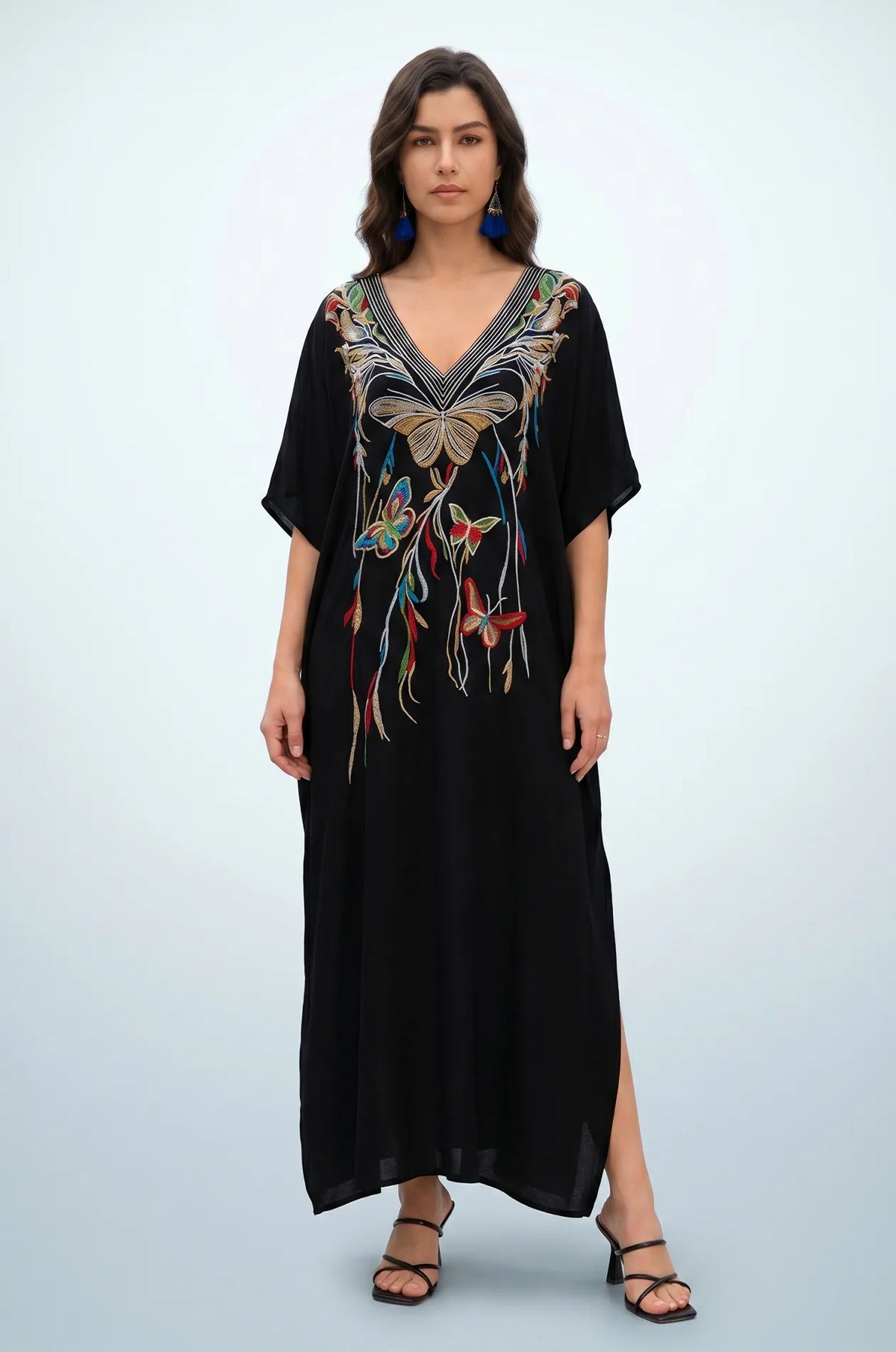 Woman wearing black beach kaftan with multicolor butterfly embroidery front view