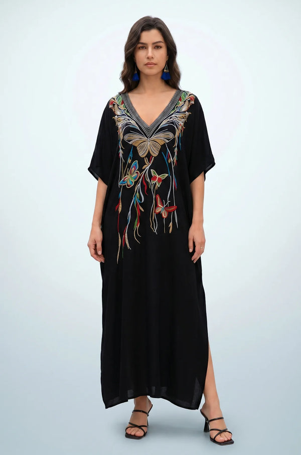 Woman wearing black beach kaftan with multicolor butterfly embroidery front view