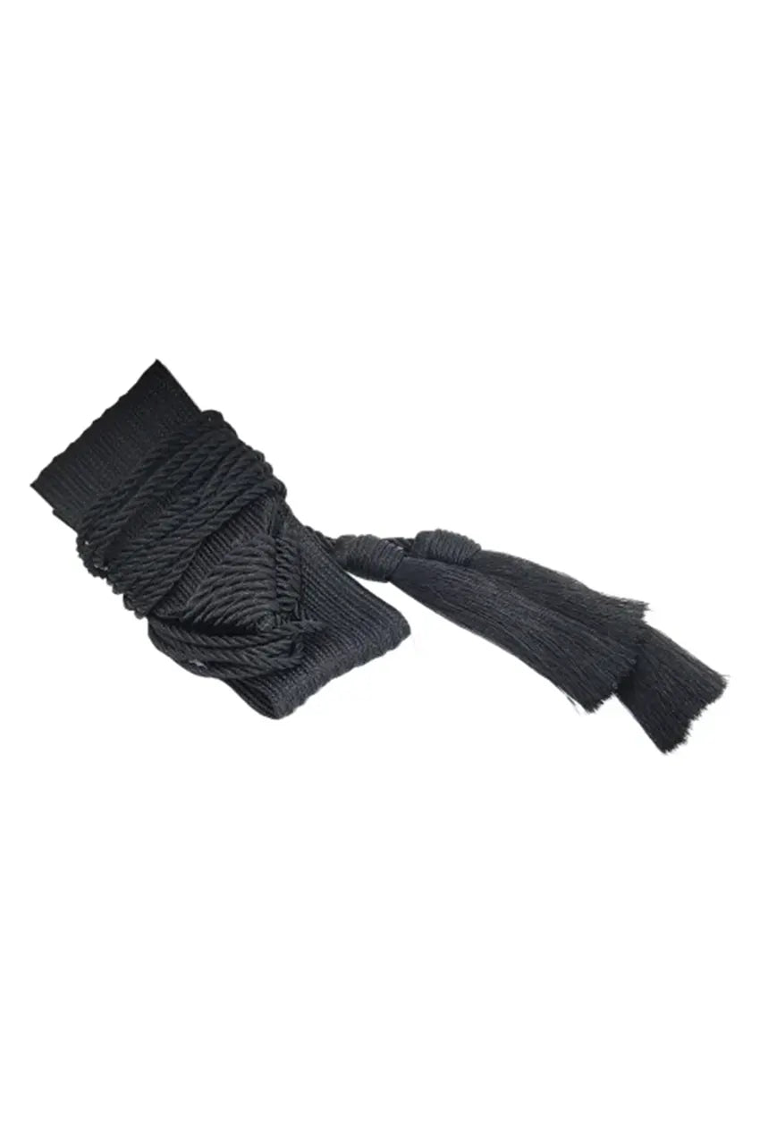 Macro detail of the black woven fabric texture and rope knot connection.