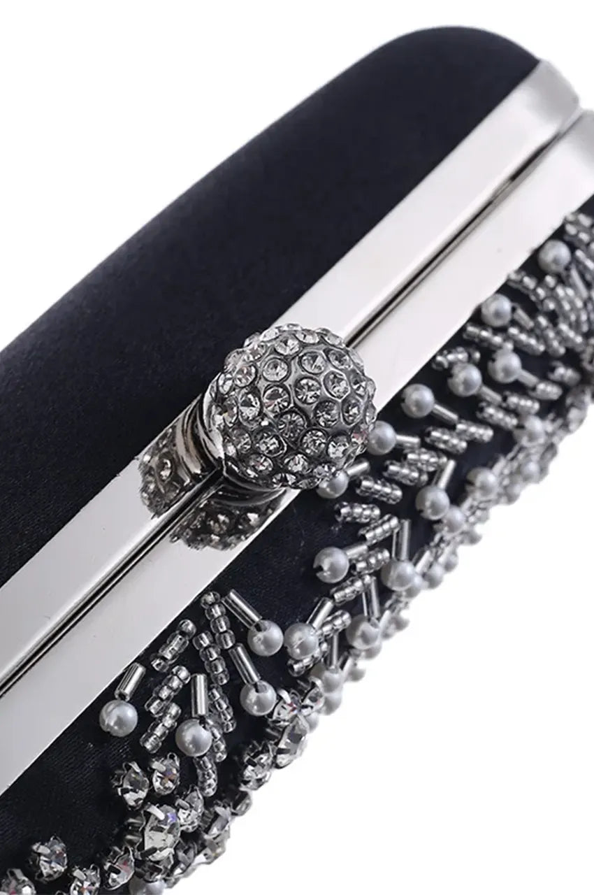 Close-up detail of the pave rhinestone ball clasp and silver metal rim on the black beaded evening bag.