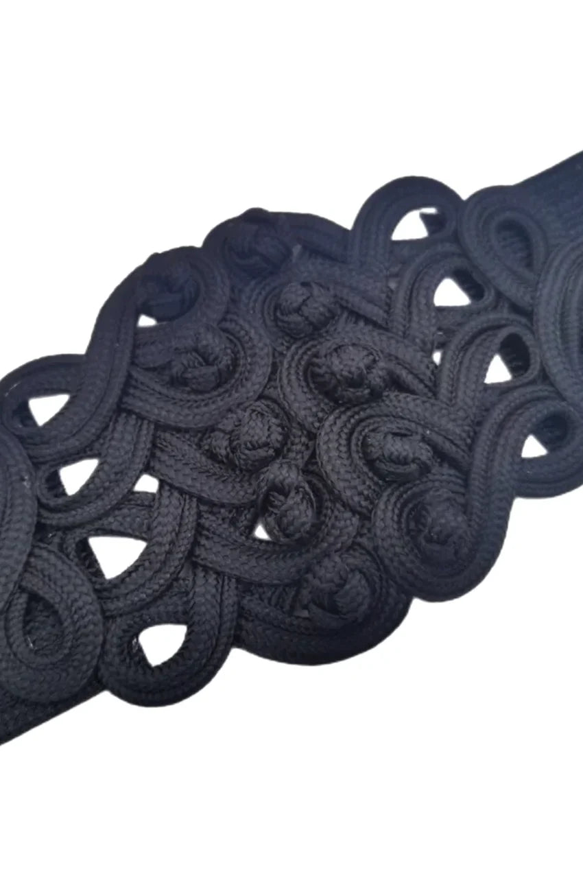 Close-up of intricate black braided knot embroidery on wide sash belt.