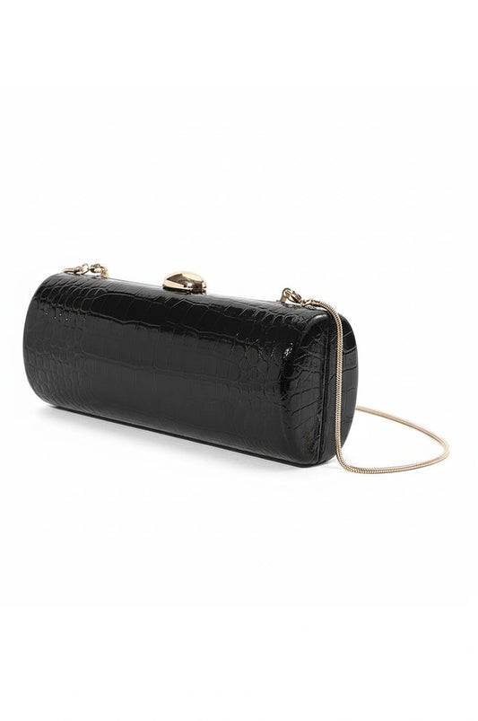Angled view of the black hard shell cylinder clutch showing the rounded profile and gold chain attachment.