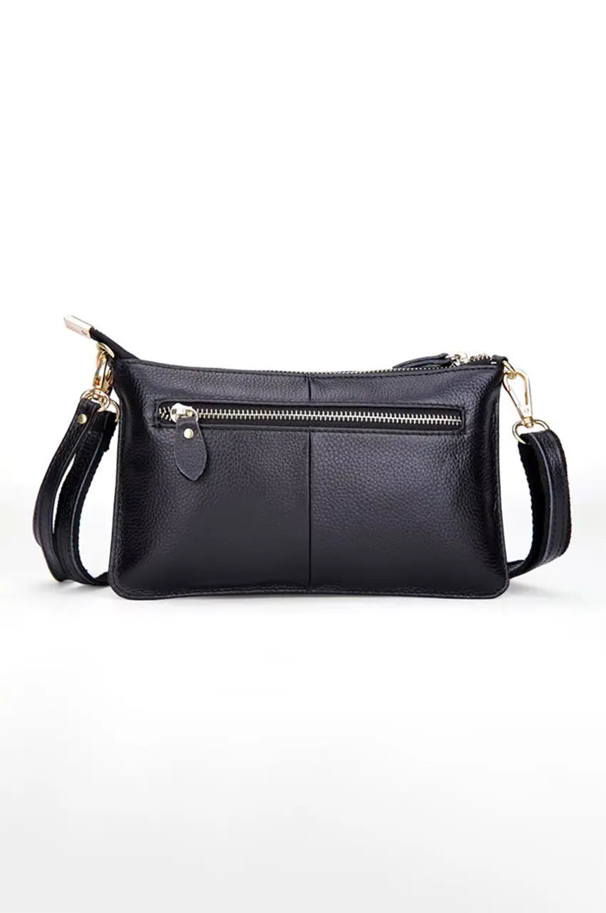 Back view of the black leather bag featuring a convenient exterior horizontal zipper pocket.