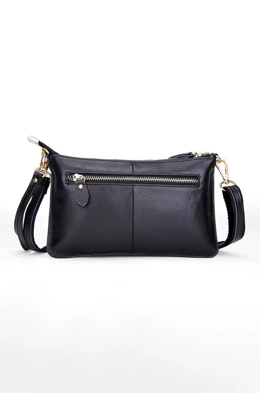 Back view of the black leather bag featuring a convenient exterior horizontal zipper pocket.