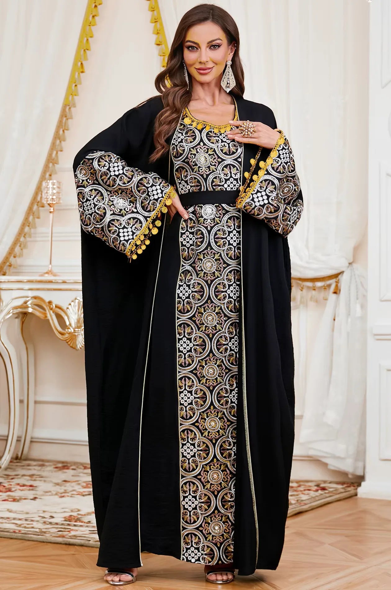 Sophisticated standing pose of the Black Novae crepe kaftan showcasing the handcrafted gold tassels and the belted waistline.