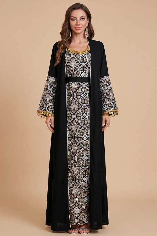 Studio front shot of the elegant Black Novae crepe kaftan showcasing intricate silver and gold patterns and tassel finishes.