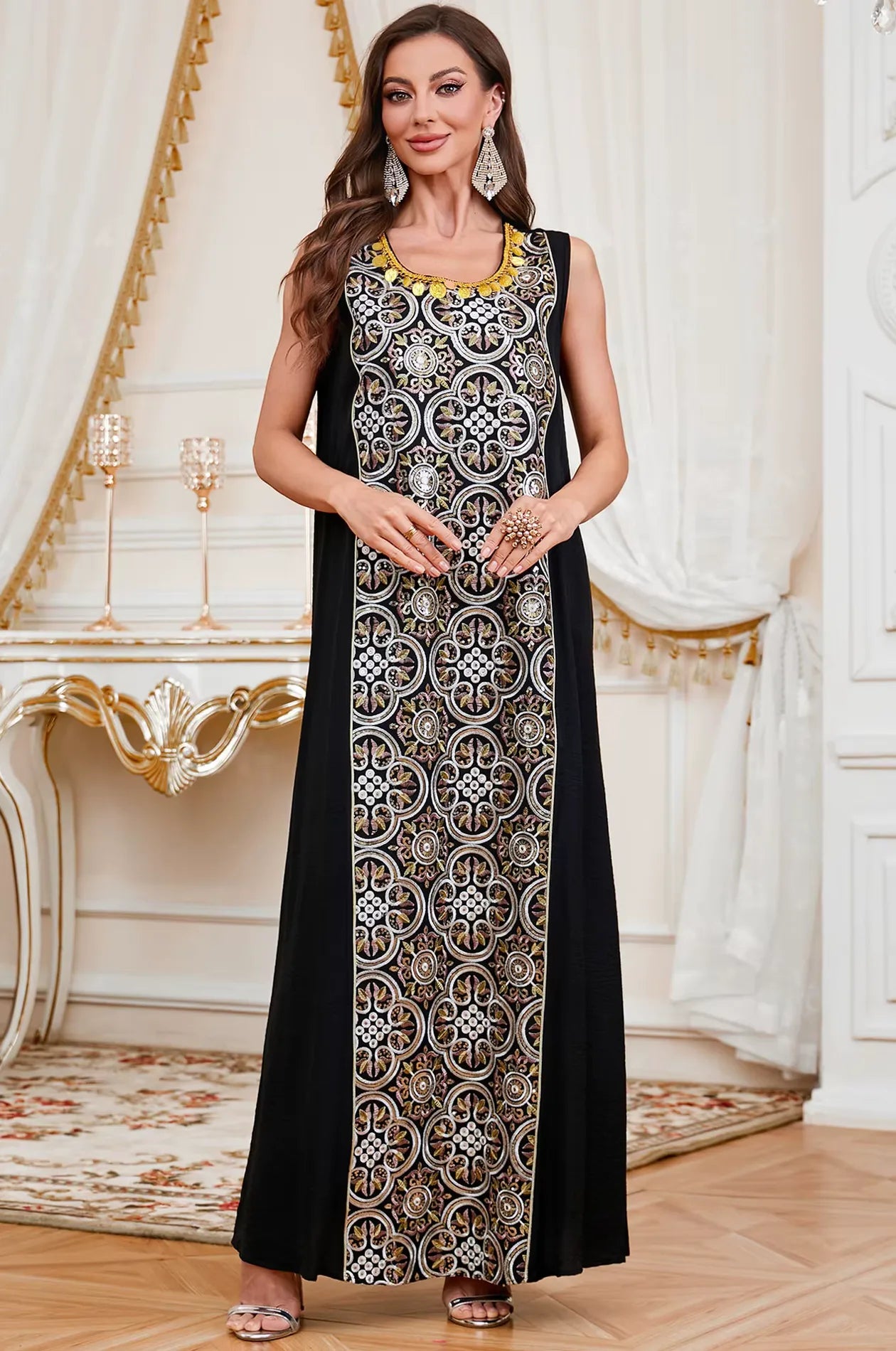 The inner sleeveless black crepe dress of the Novae kaftan set featuring a central panel of gold and silver embroidery.