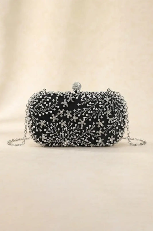 Front view of black oval hard-shell clutch with elaborate hand-beaded floral design using faux pearls and crystals, ideal for evening Kaftans.