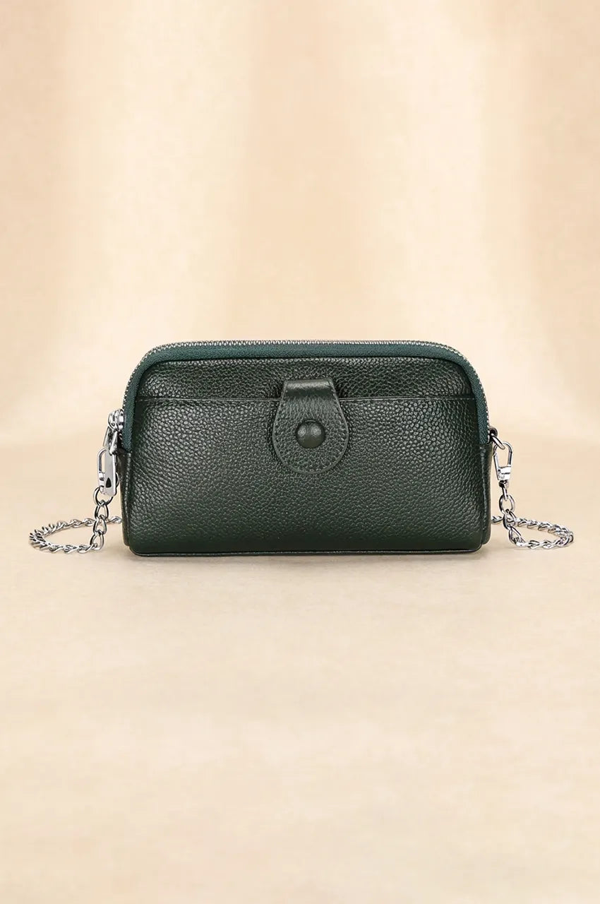 Front view of black pebbled leather crossbody phone bag with snap pocket and silver chain strap.