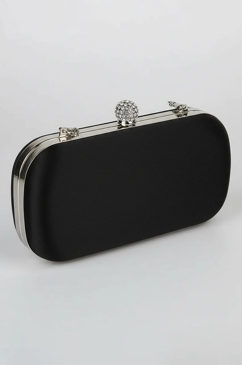 Back view of black satin evening clutch featuring a smooth finish and sleek silver metal frame.