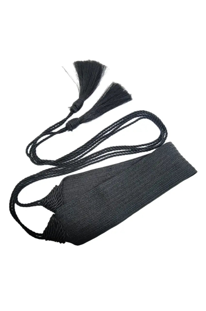 Overhead view of the black sash belt ties and tassels laid out flat.