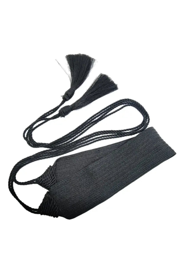 Overhead view of the black sash belt ties and tassels laid out flat.