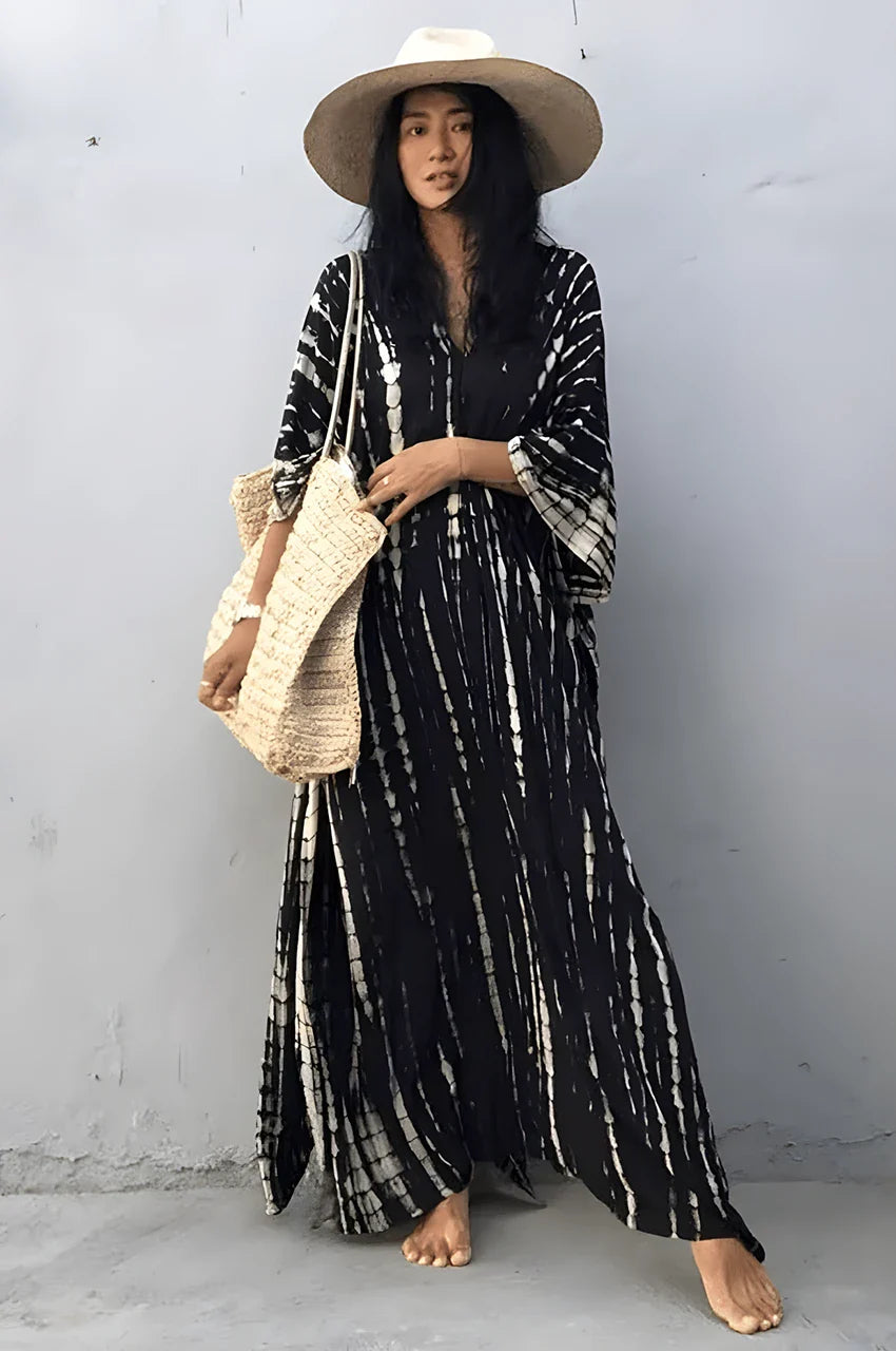 Lifestyle image of Sahra Black Tie Dye Kaftan styled with sun hat and beach bag