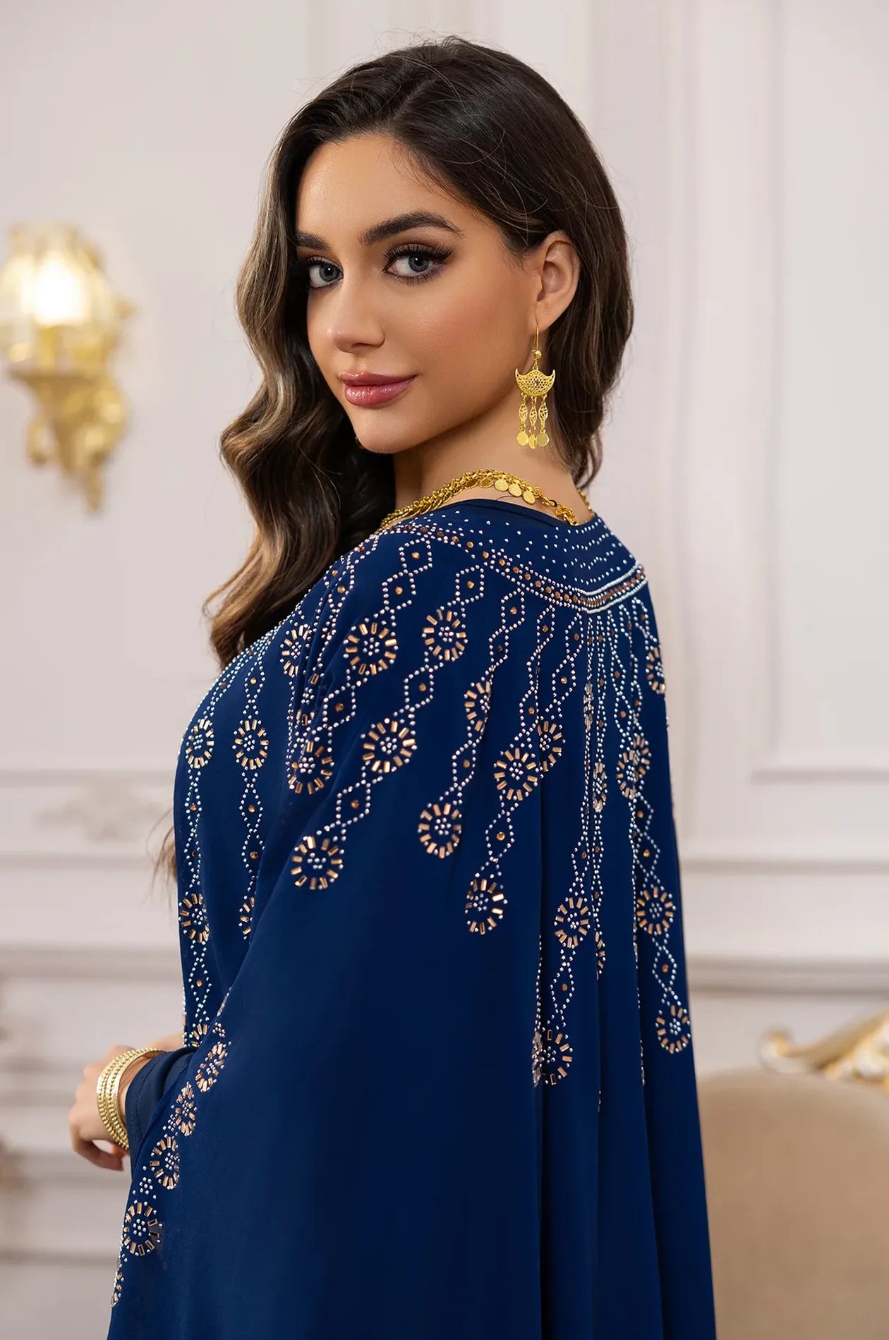 Side profile view highlighting the intricate crystal shoulder and back embroidery on the Navy Blue Cassia.