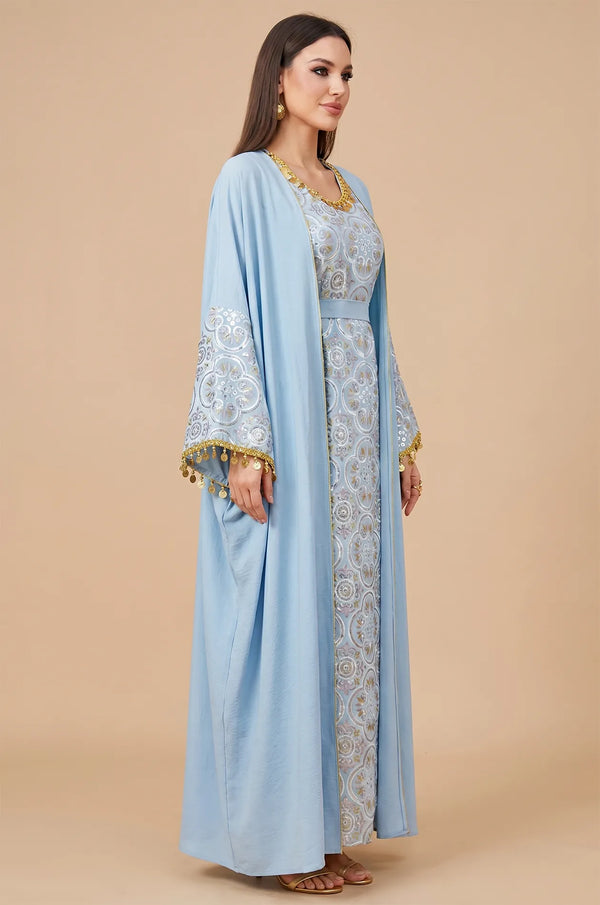 Three-quarter side profile of the sky blue Novae crepe kaftan highlighting the flared sleeves and silver patterns.