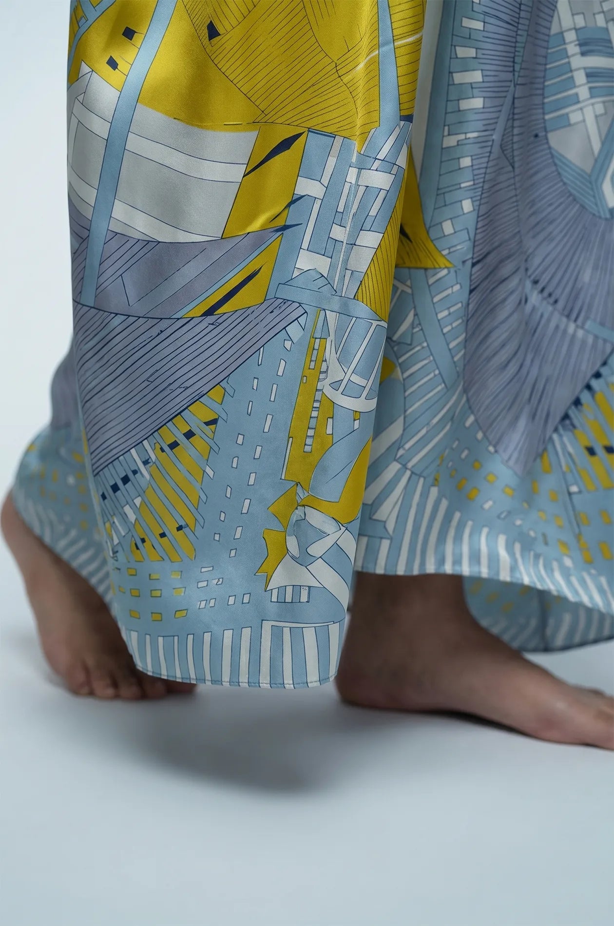 Hem detail of blue silk kaftan showing yellow and grey geometric print