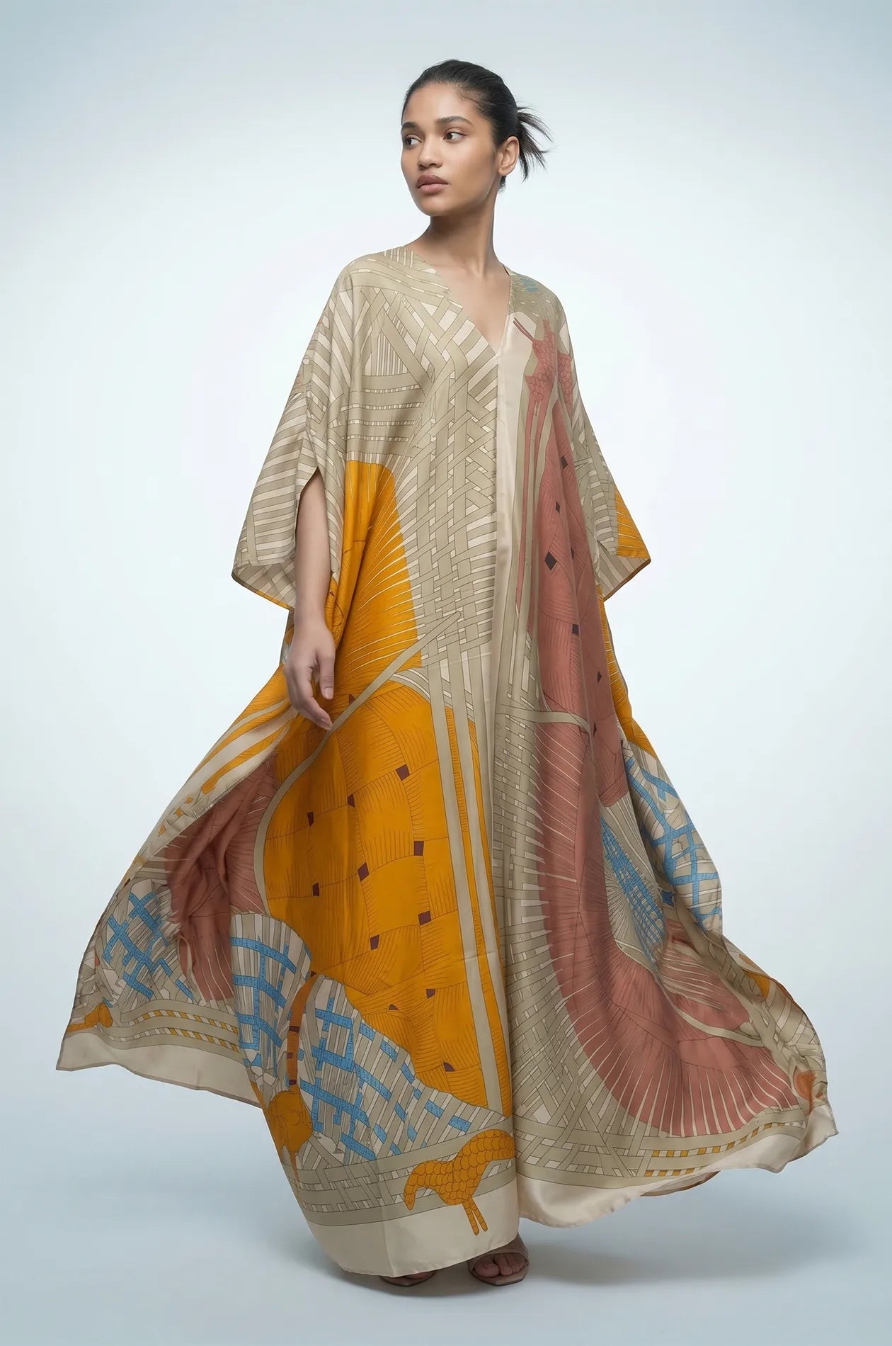 Green boho beach kaftan in motion showing fluid silk maxi silhouette
