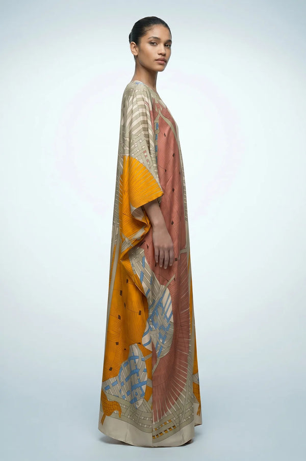 Side profile of green Lupis kaftan showing flowing silk-touch drape