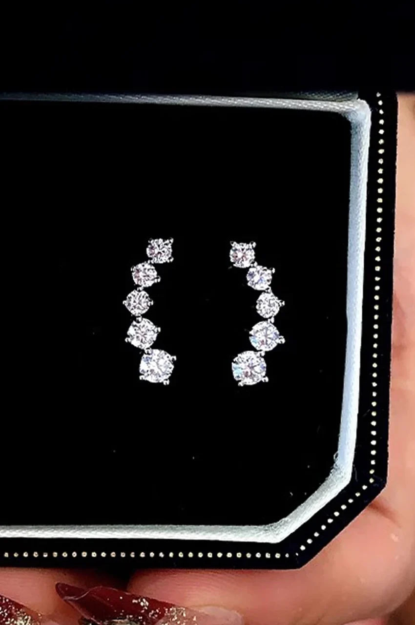 Pair of sparkling silver crystal ear climbers displayed in a black velvet jewelry box.
