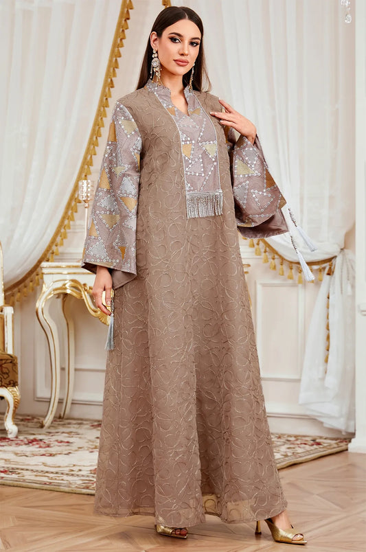 Fashion shot of the Brown Kaliera embellished kaftan, displaying the warm taupe fabric and contrasting geometric paneling.