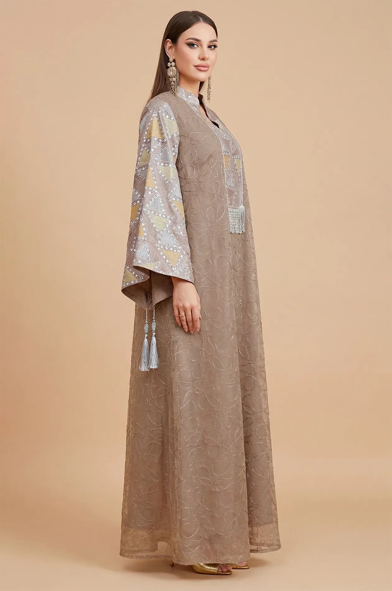 Side profile of the Brown Kaliera geometric kaftan, highlighting the fluid drape of the fabric and the flared sleeve design.