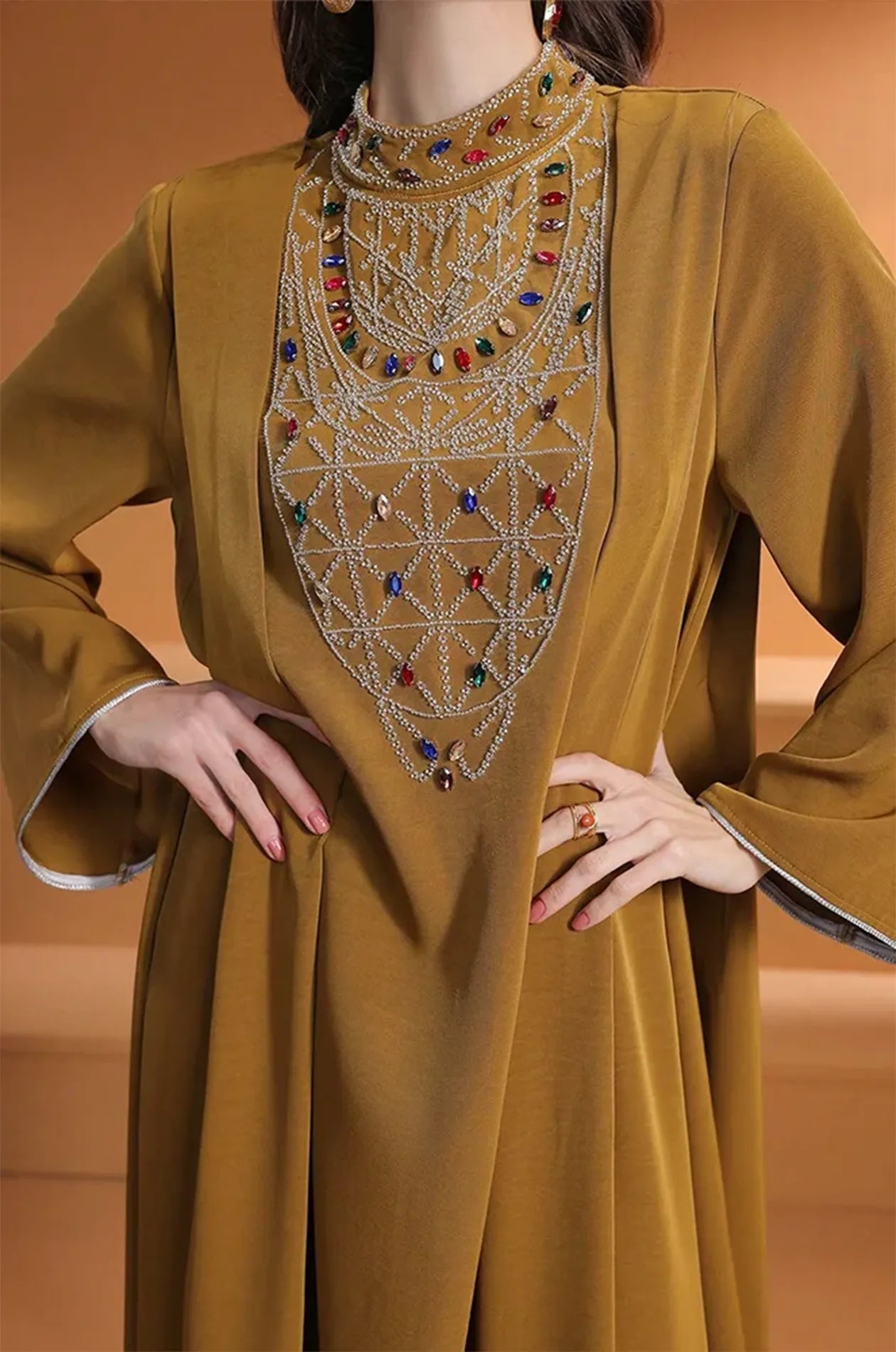 Extreme close-up of the hand-beaded crystal and rhinestone lattice on the chest.