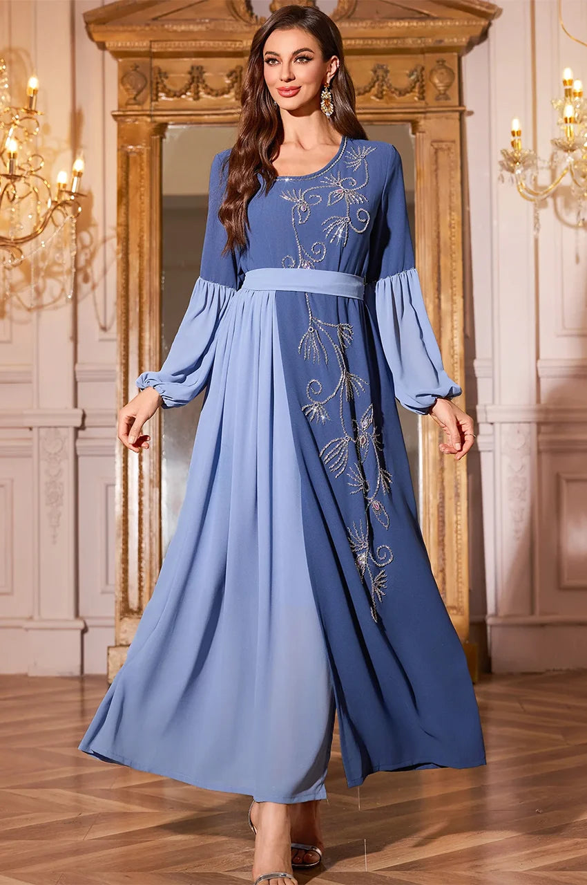 Model modeling the Zaria luxury kaftan with embroidery details.