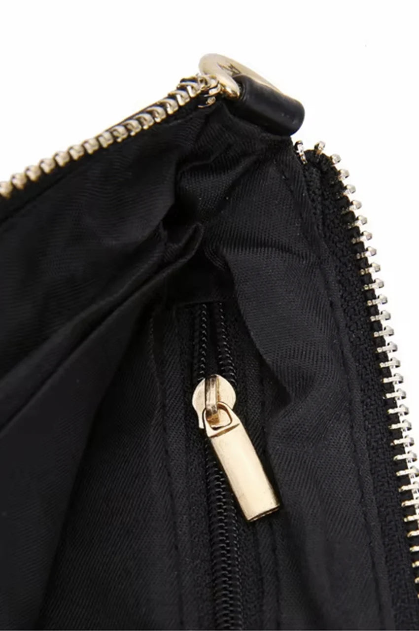 Close-up of the bag's interior showing durable black lining and a secure internal zipper pocket with gold hardware.