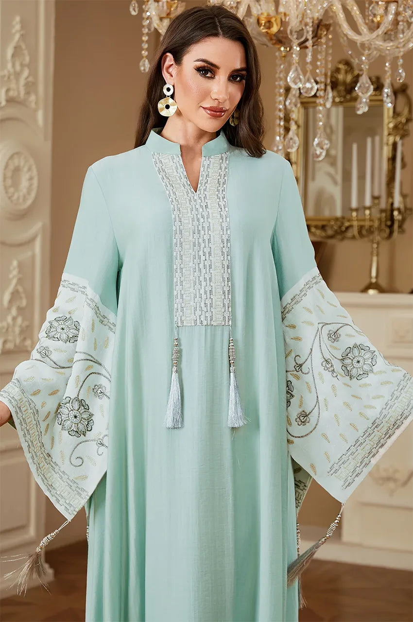 Close-up shot of the Cyan Nairi kaftan bodice and tassels, emphasizing the premium cotton fabric and artisanal embroidery