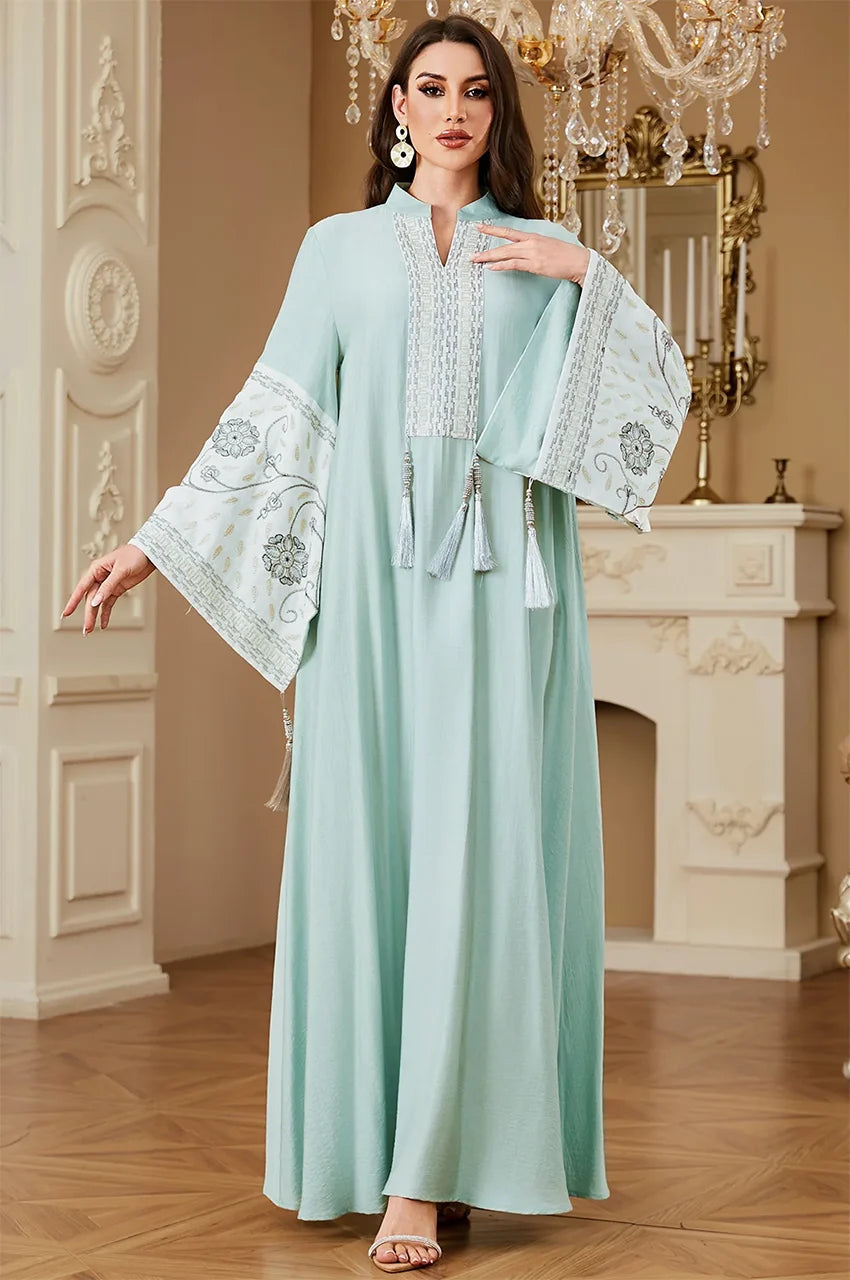 Model posing in the Cyan Nairi cotton kaftan maxi, showing the delicate white sfifa trim along the neckline and cuffs