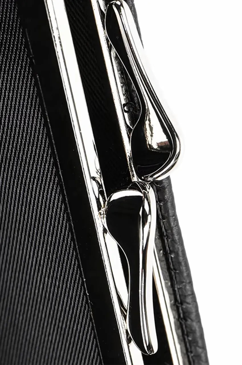 Close-up of the durable metal hinge and frame construction on the hard shell cylinder evening bag.